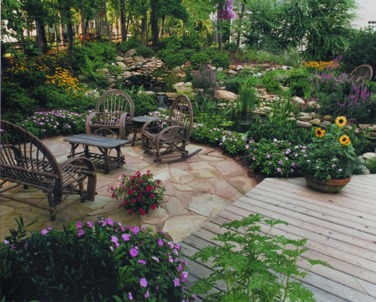 Patio & Deck surrounded by lush landscape